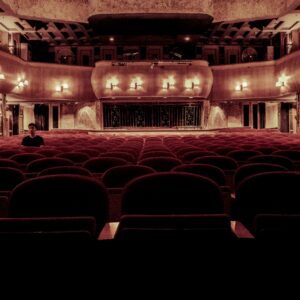 An elegant vintage theater with plush velvet seats and warm lighting, perfect for a serene cinematic experience.